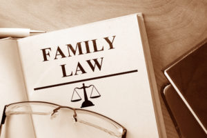 Family Lawyer Shelton, CT - Book open to page that reads family law on table with glasses on top