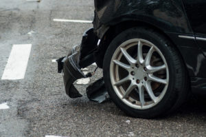 Closeup of a car with a smashed front fender