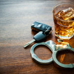 Drunk Driving Lawyer - handcuffs whiskey and car keys