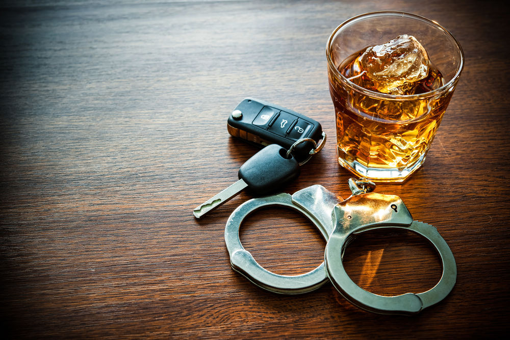 Drunk Driving Lawyer - handcuffs whiskey and car keys