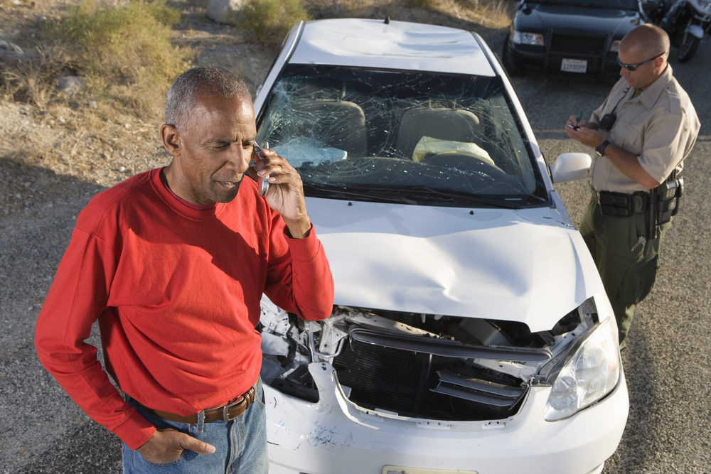 Common Causes of T-Bone Accidents - Man talking on phone after car accident