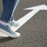 Davis, Johnson & Kallal| Wyoming Law - Woman going along road with arrow marking, closeup