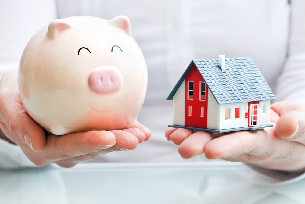 Questions Your Estate Planning Lawyer May Ask - Hands holding a piggy bank and a house model