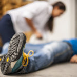 Common Places Where Slip & Fall Accidents Occur - man on floor with woman assisting