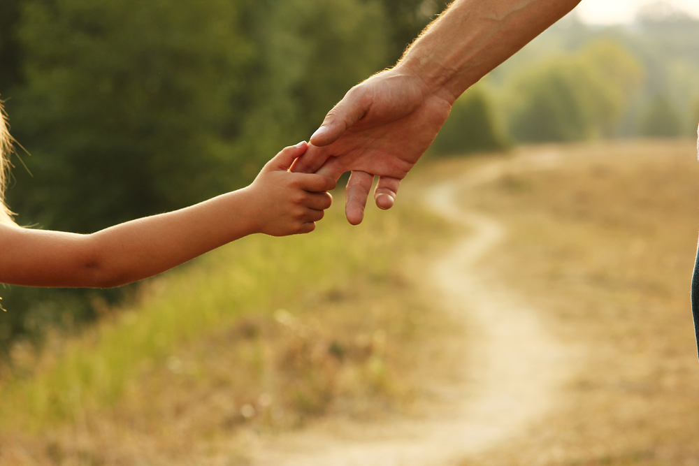 The Benefits Of A Child Custody Lawyer - parent holds the hand of a small child