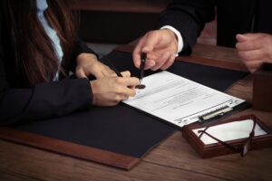 divorce lawyer Shelton CT with attorneys signing a document